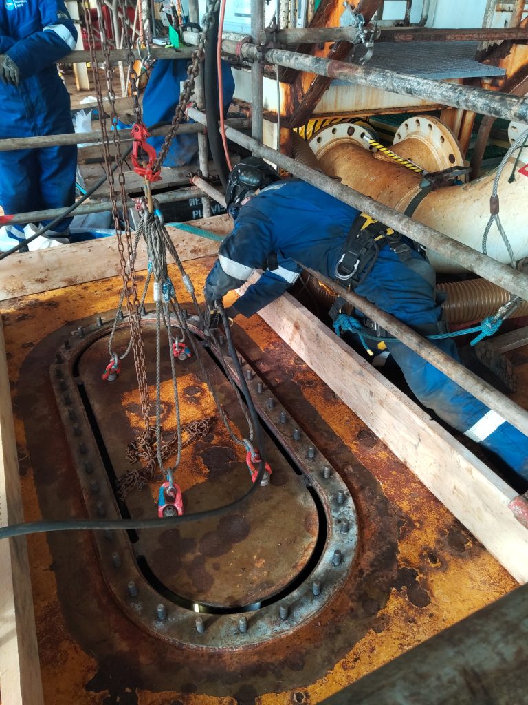 MTL technician performs final tab cuts during on-station hatch installation.