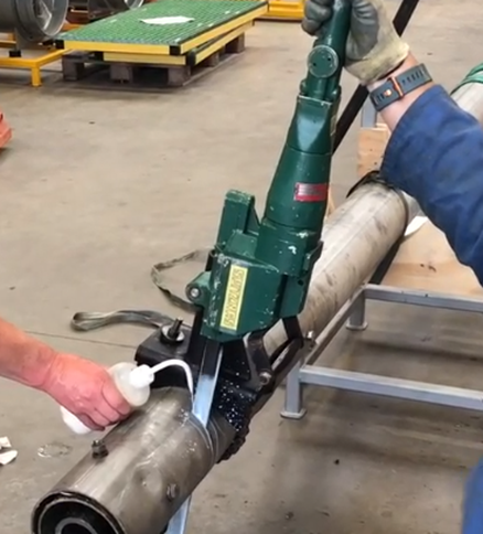 pipestack being cut into smaller sections using an electric reciprocating saw.
