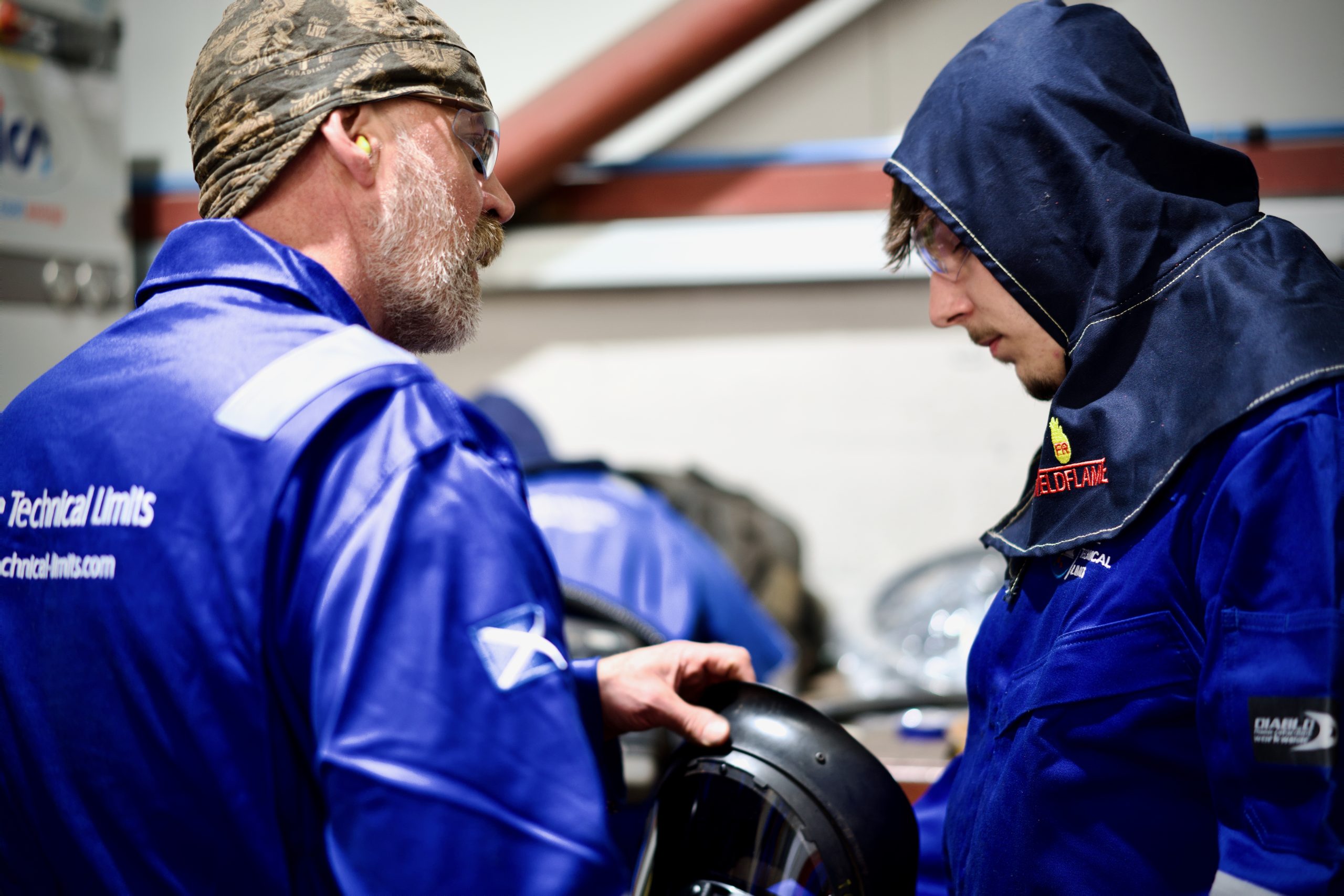 Experienced technician teaching a young student