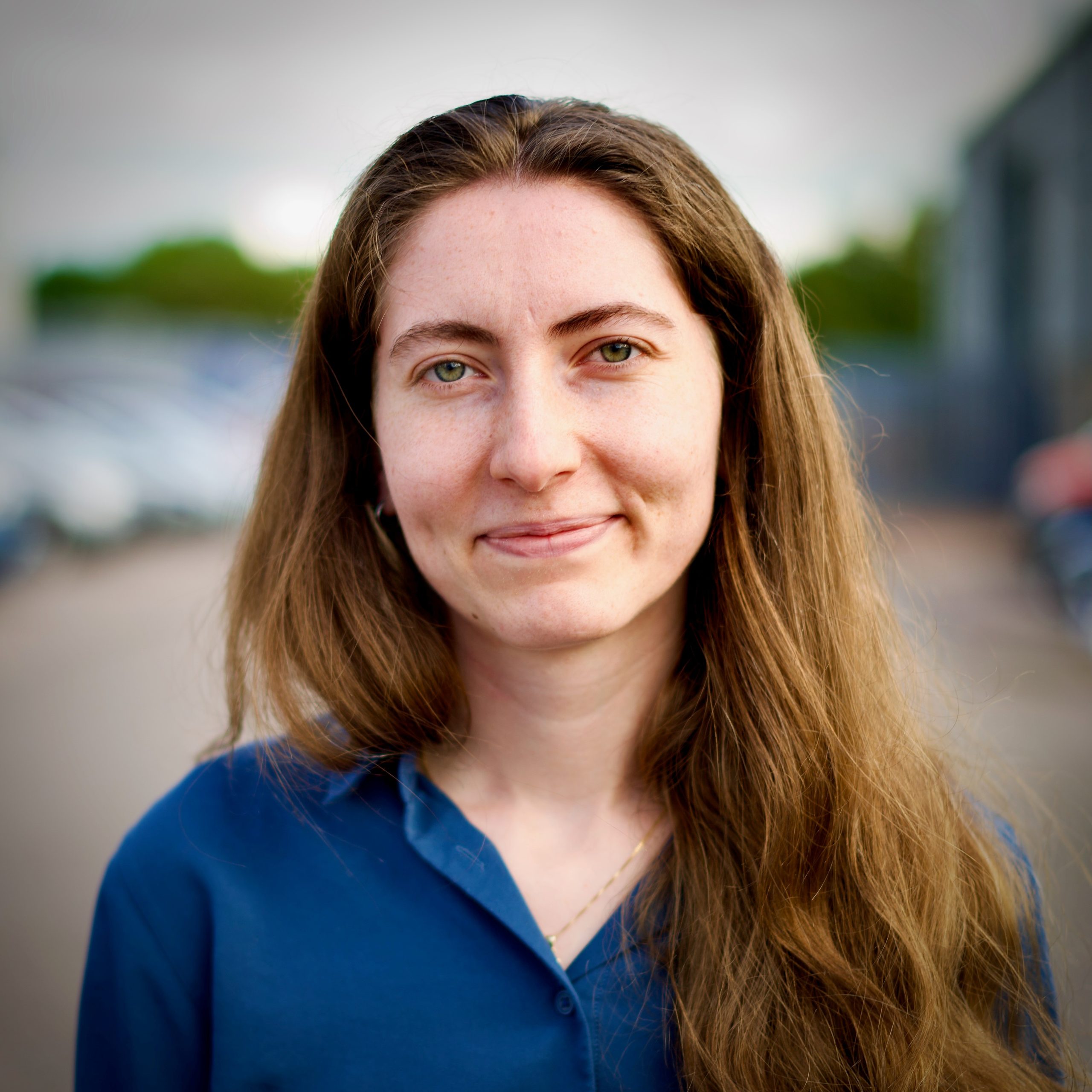 A portrait photograph of a smiling young lady
