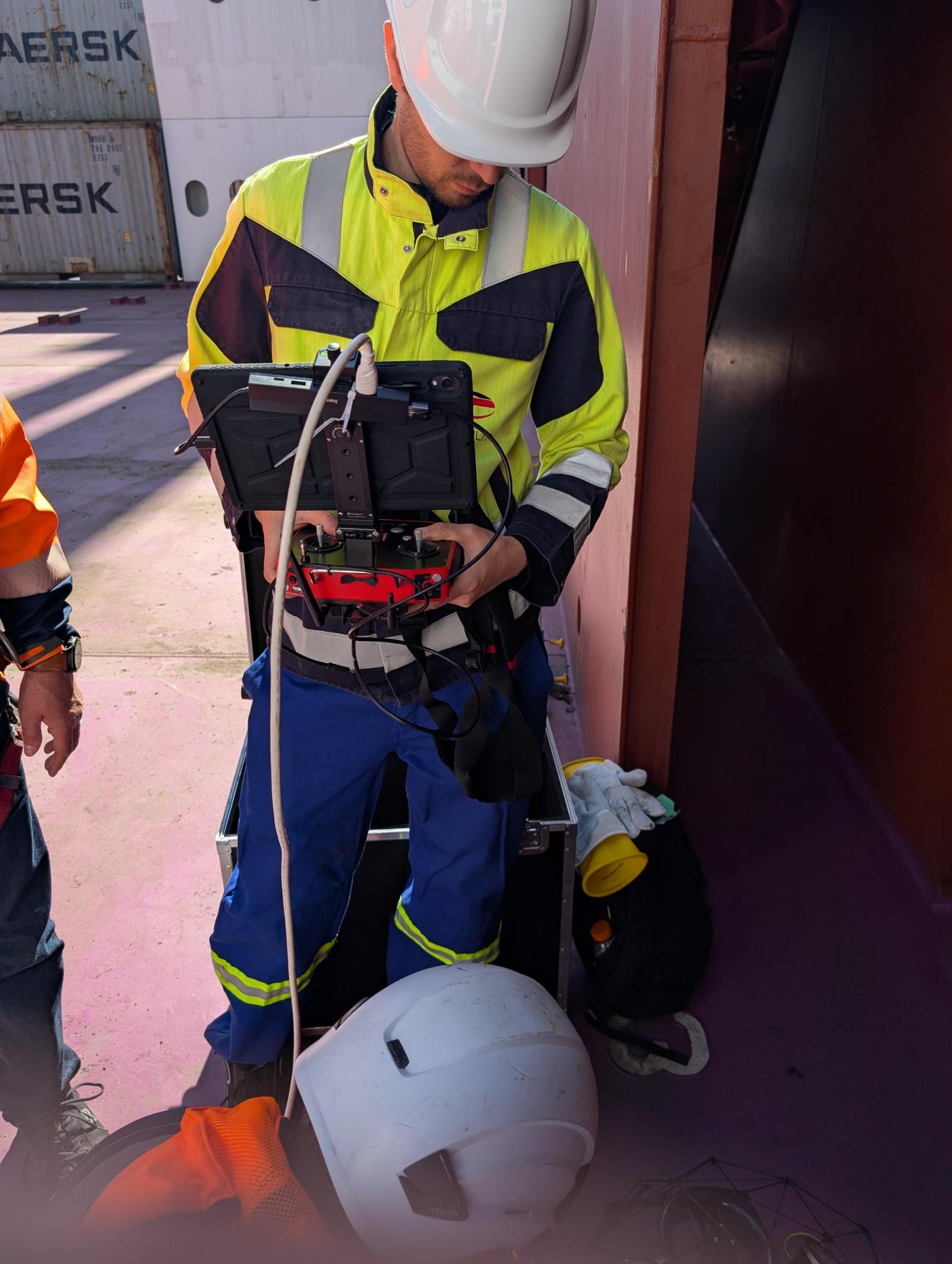 UAV operator concentrating on live feed and controller