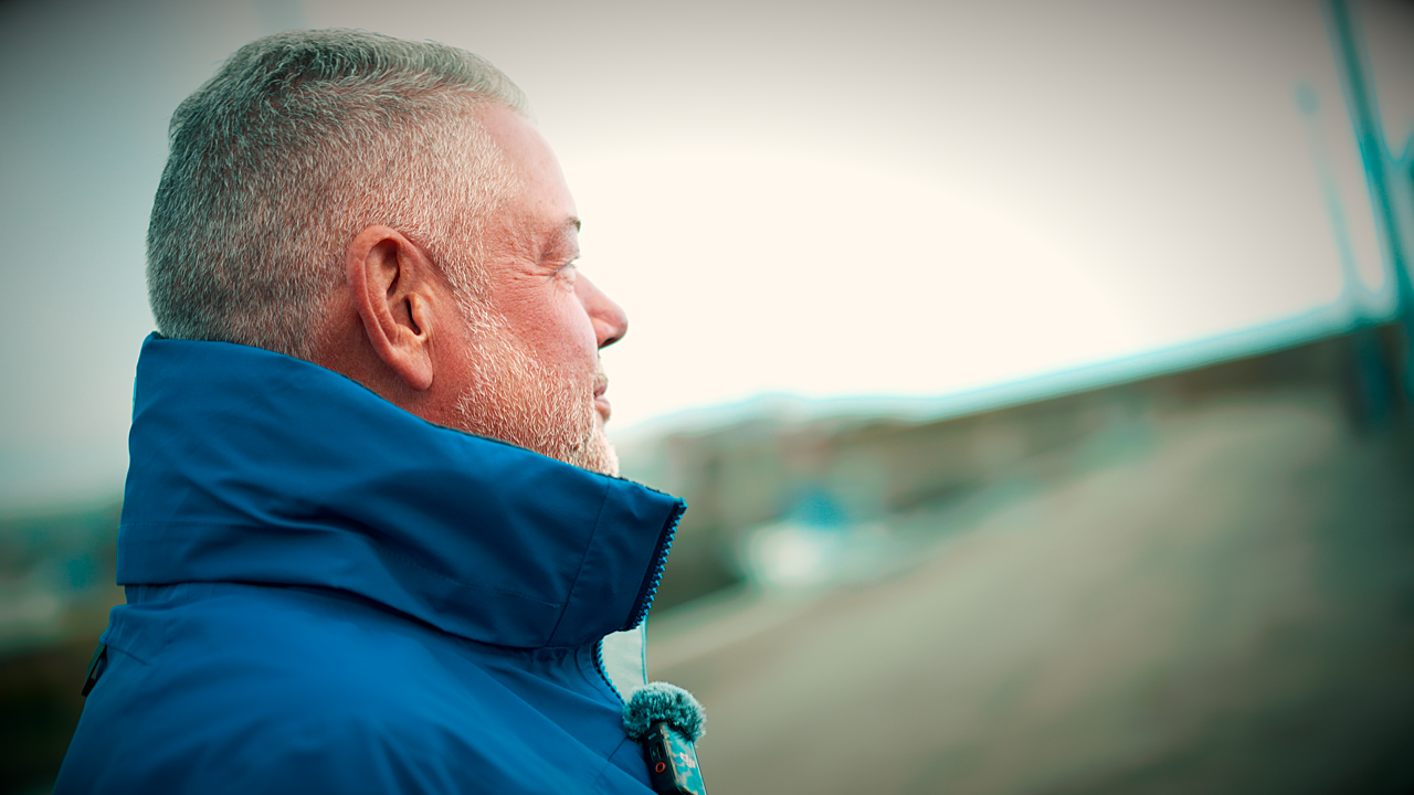 image of sailor looking out to sea, reflecting happily 
