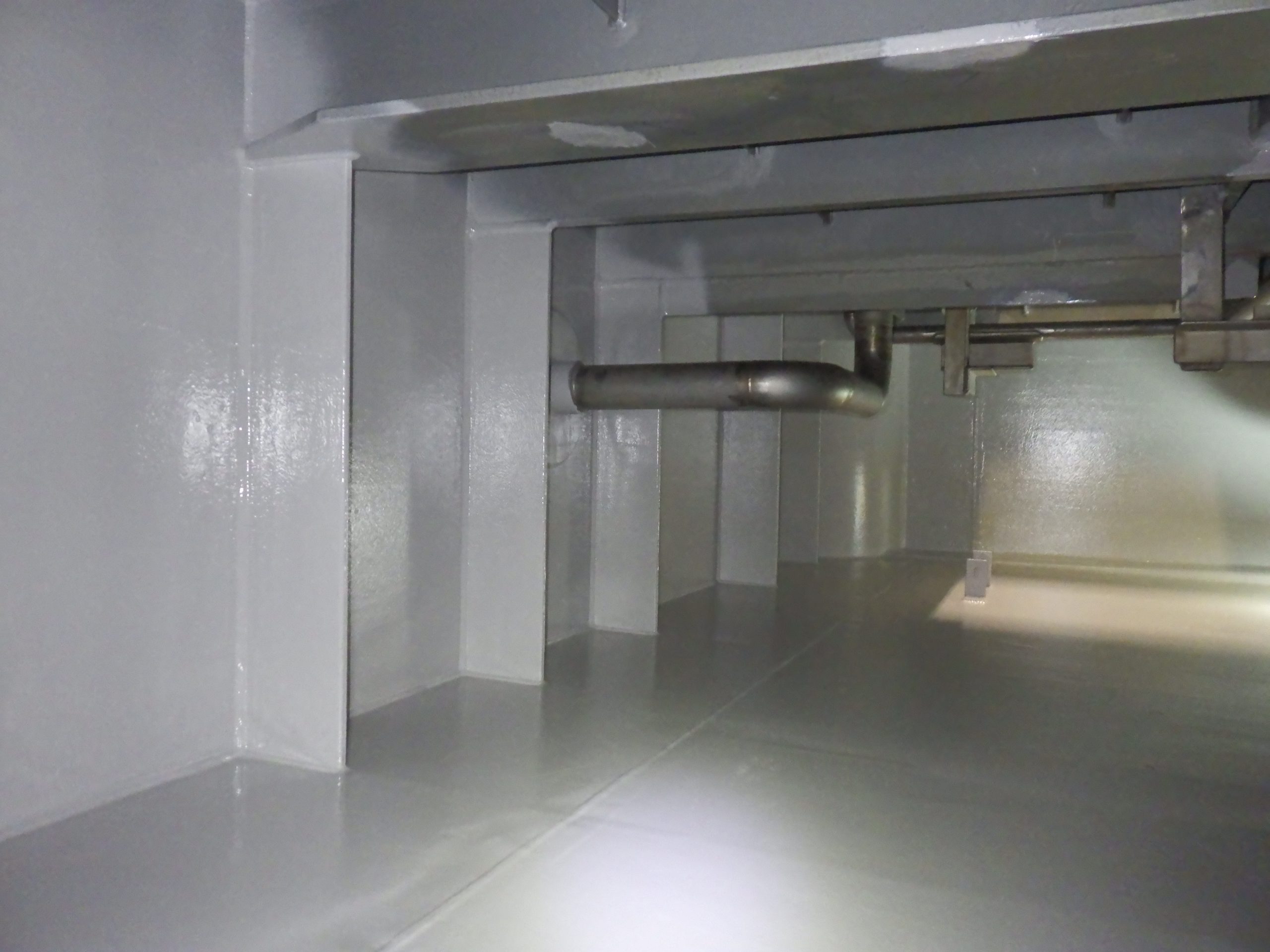 Freshwater tank interior following coating refurbishment, showing clean coated steel surfaces and improved environmental conditions